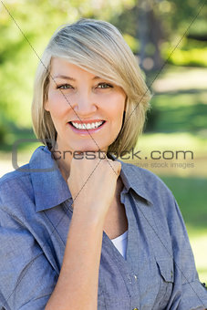 Woman with hand on chin in park