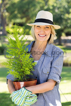 Woman holding potted plant for gardening