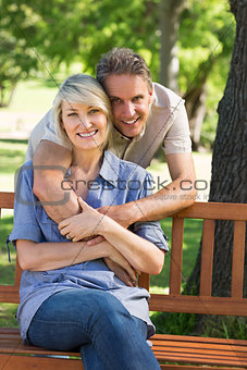 Loving man embracing woman in park