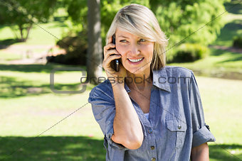 Woman talking on mobile phone in park