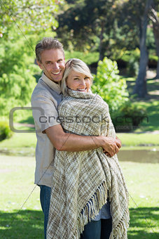 Smiling couple embracing in park