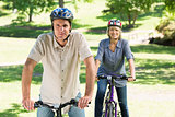 Couple bike riding in park