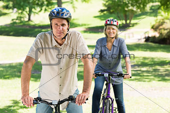 Couple bike riding in park