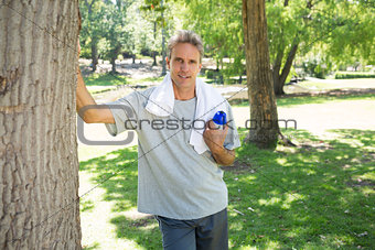 Man with bottle of water in park