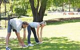 Active couple exercising in park