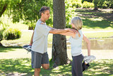 Couple stretching legs in park