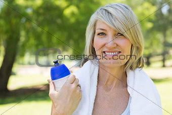 Woman holding water bottle in park