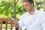 Businessman reading text message on mobile phone