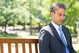 Businessman relaxing on park bench