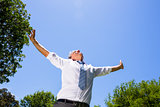 Carefree businessman with arms outstretched