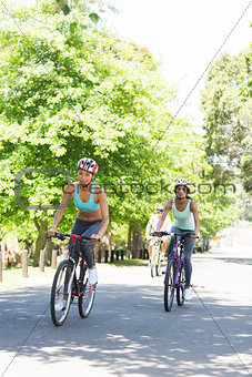 Sporty women riding bicycles