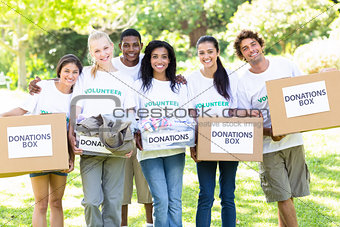 Volunteers carrying donation boxes