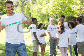 Handsome volunteer pointing at tshirt