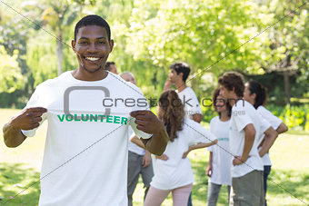 Portrait of happy volunteer holding tshirt