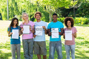 Friends holding blank papers