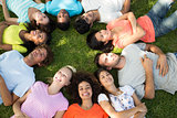 Multiethnic friends lying down in park