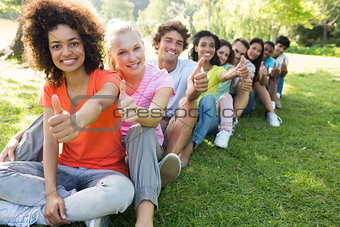 University students gesturing thumbs up