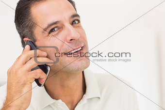 Closeup portrait of a smiling man using mobile phone