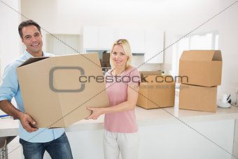 Smiling couple moving together in a new house