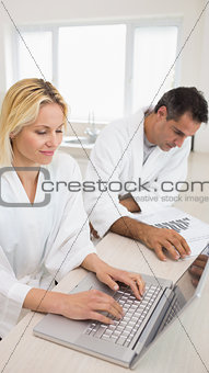 Couple with bills and laptop in the kitchen
