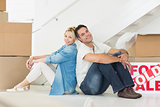 Smiling couple with boxes in a new house