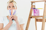 Woman holding color swatches in new house