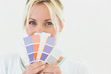 Closeup portrait of a beautiful woman holding color swatches