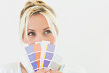 Closeup of a beautiful young woman holding color swatches