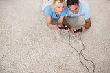 Couple playing video games on area rug