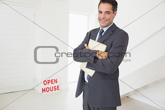 Businessman with documents at an house for sale