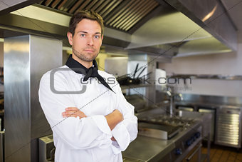 Serious male cook with arms crossed in kitchen