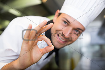 Closeup of a smiling male cook gesturing okay sign