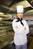 Portrait of confident female cook in kitchen