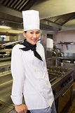 Smiling female cook in kitchen