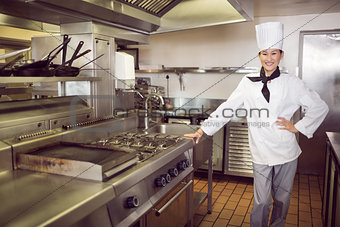 Smiling female cook in the kitchen