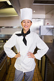 Portrait of smiling female cook in kitchen