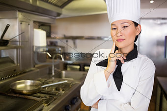 Portrait of confident female cook in kitchen