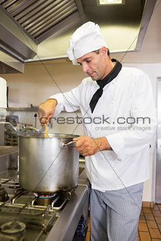 Concentrated male chef preparing food in kitchen