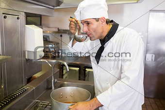 Male cook tasting food in kitchen