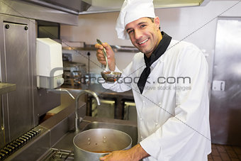 Smiling chef preparing food in the kitchen