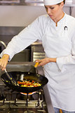 Concentrated female chef preparing food