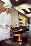 Female chef preparing food in kitchen