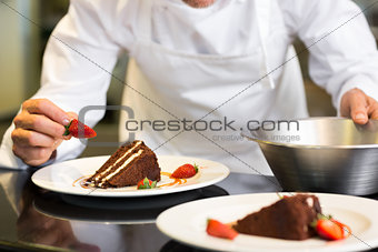 Mid section of pastry chef decorating dessert
