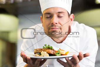Closeup of a chef with eyes closed smelling food