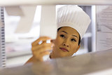 Female chef going through cooking checklist at kitchen
