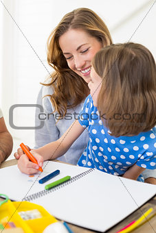 Mother with daughter coloring at home