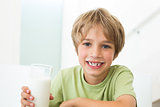 Happy boy with glass of milk