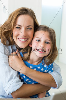 Loving mother embracing daughter