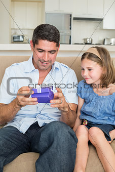 Father opening gift given by daughter