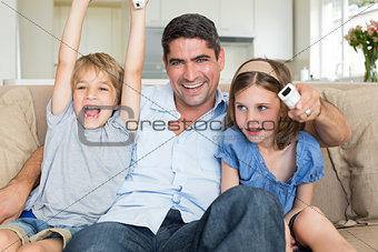 Father with children watching TV
